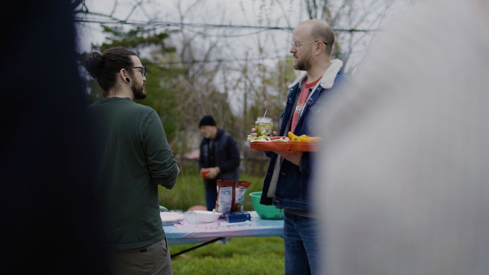 Characters gathered by a backyard table