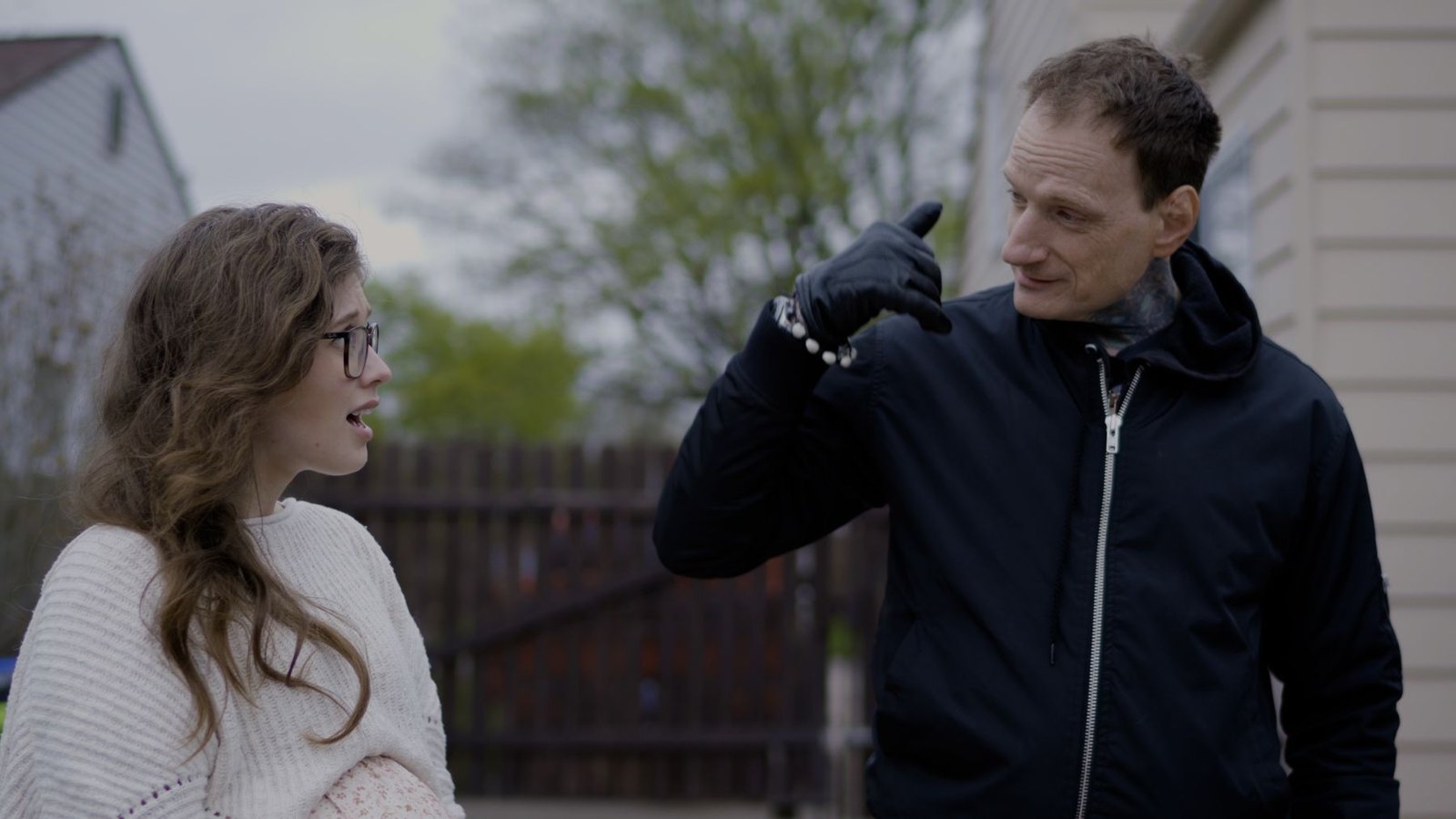 Two characters talking outside