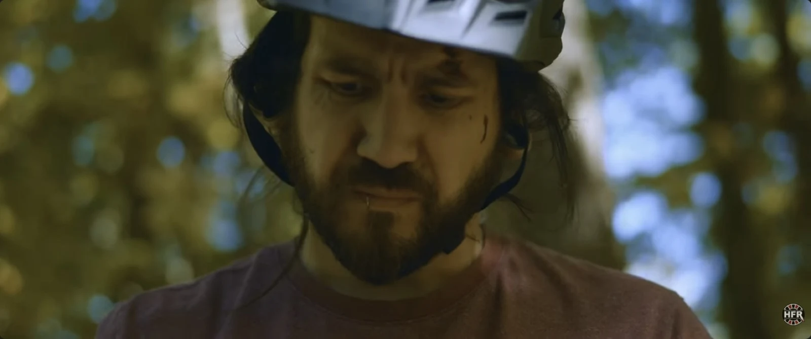 Trail Dead: a helmeted man in the woods
