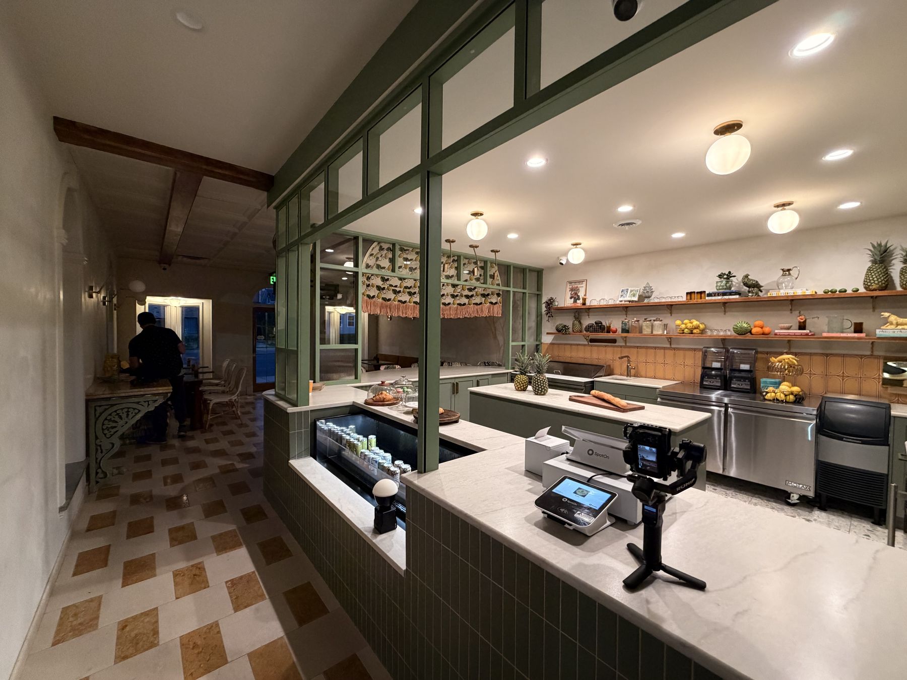 The Le Juicé counter : green millwork, terrazzo and brass